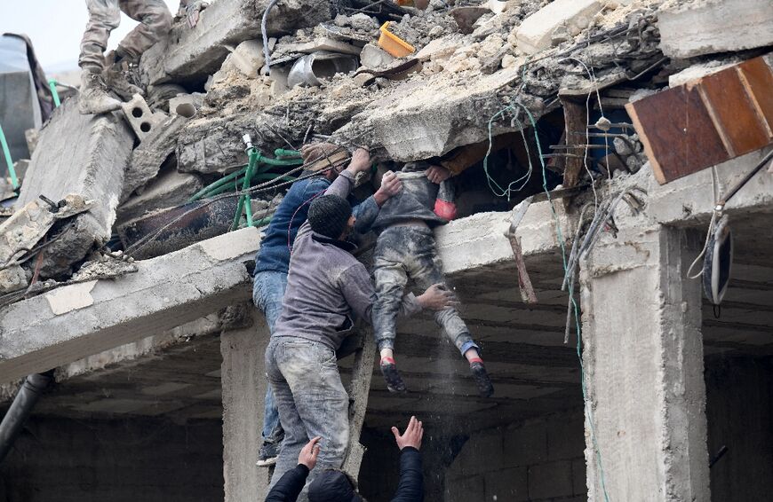 Residents retrieve an injured girl from the rubble of a collapsed building following an earthquake in the town of Jandairis