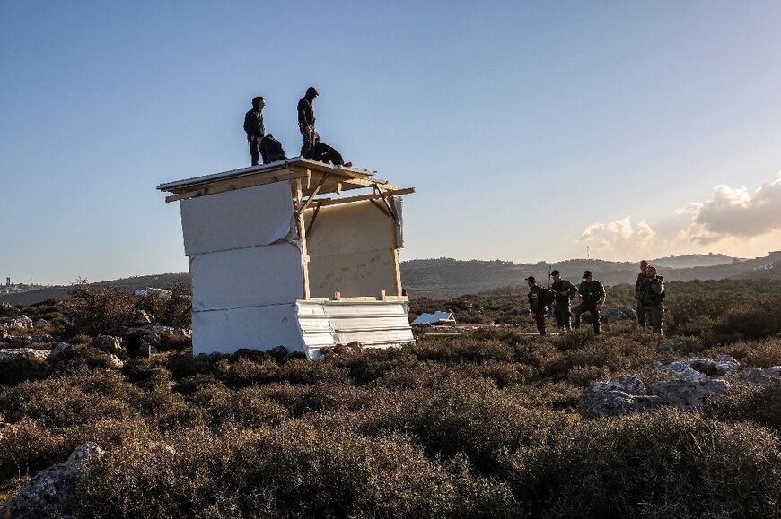 Israeli border police evict Jewish settlers attempting to rebuild the outpost of Or Haim in the occupied West Bank after it was demolished on defence ministry orders last month