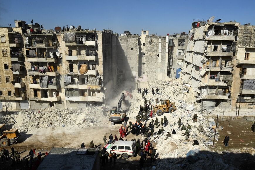 Rescuers sift through the rubble of a collapsed building in Aleppo
