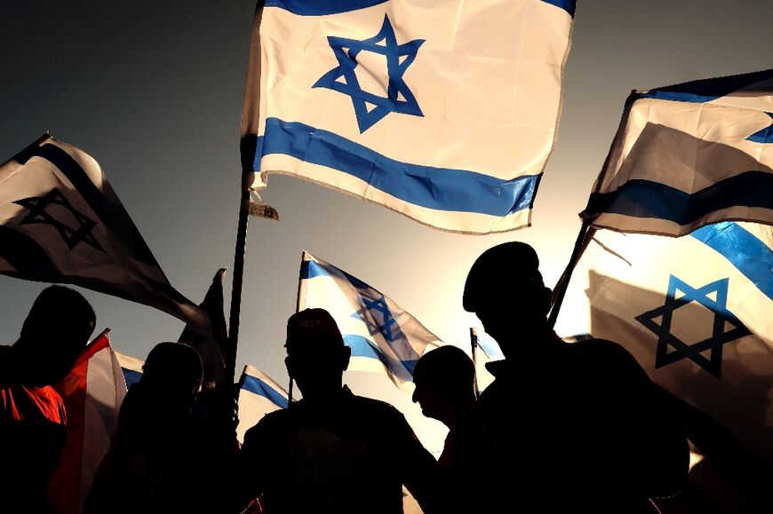 Israeli military veterans join a protest against the government's judicial reforms on a highway north of Tel Aviv