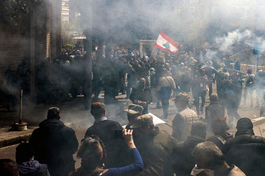Tear gas fills the air as retired Lebanese army and security forces veterans attempt to break into the government palace premises in the centre of Beirut