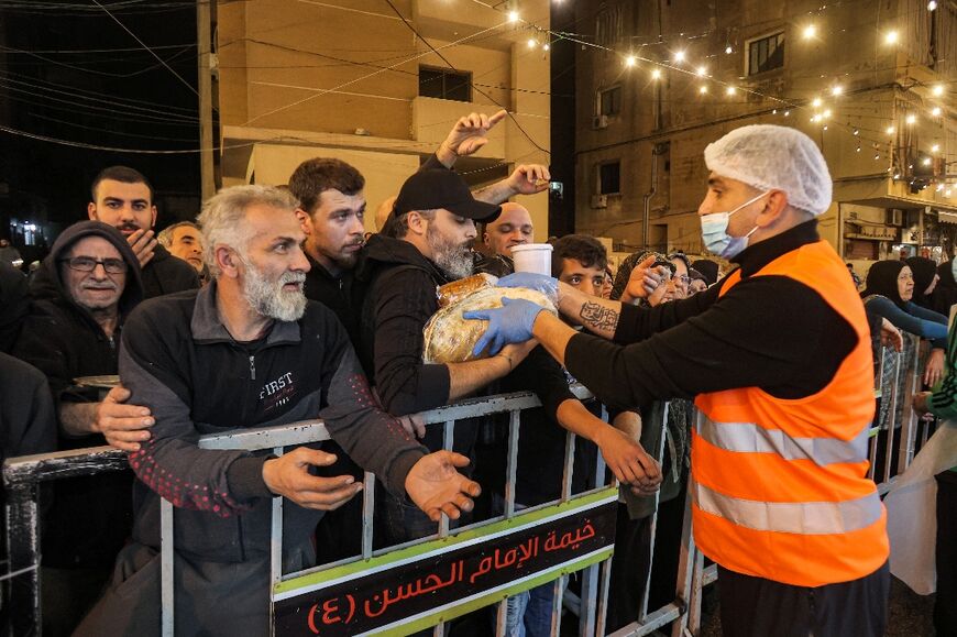 A charity volunteer hands out pre-dawn meals in Beirut during the Muslim fasting month of Ramadan