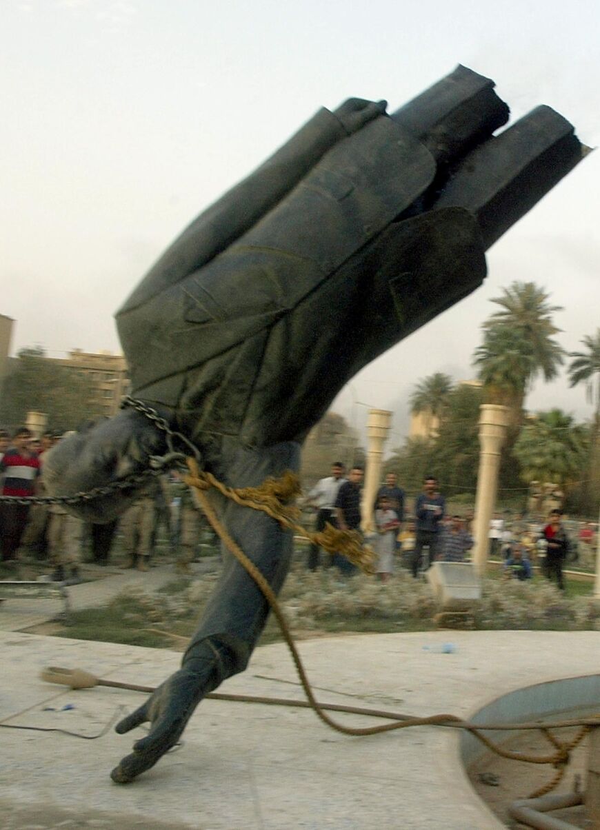 A statue of Iraqi president Saddam Hussein is pulled down by a US Marines vehicle in Baghdad's al-Fardous square, in this file photo from April 9, 2003 
