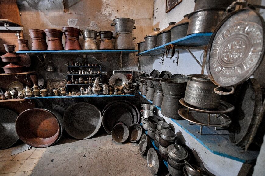 Old pots and cookware are left by customers to be polished ahead of the Muslim holy fasting month of Ramadan, at a coppersmith's workshop in the old city of Tunis 