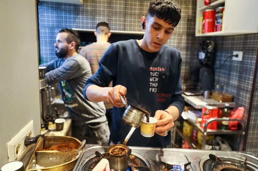 A barista prepares coffee at a cafe in Tripoli