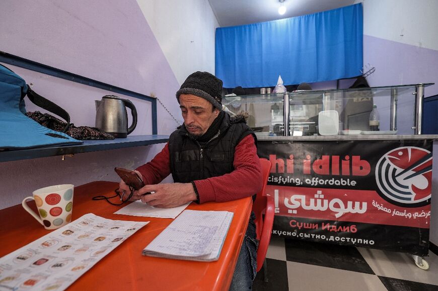 Shakhbanov sits in his 'Sushi Idlib' restaurant, which he says he was inspired to open after sampling Japanese cuisine during his travels