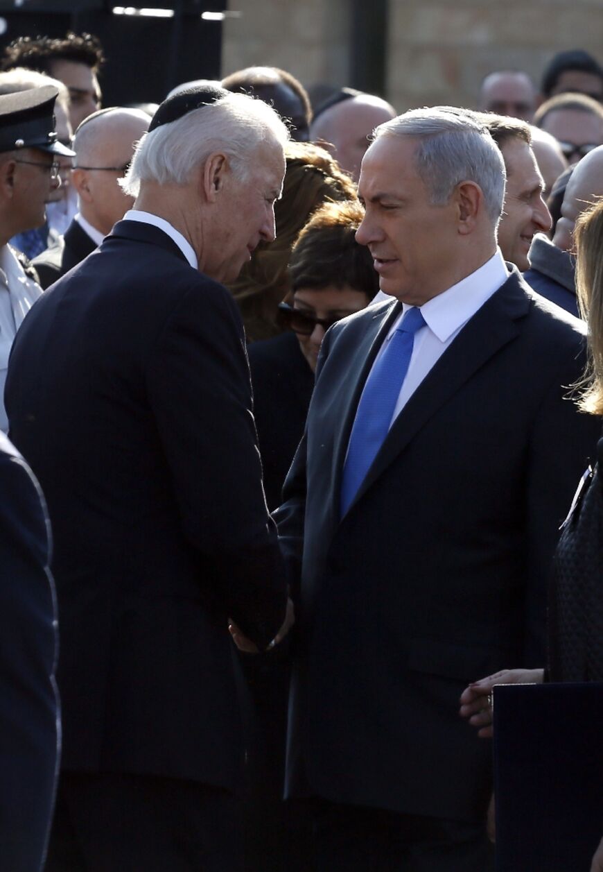 Israeli Prime Minister Benjamin Netanyahu  shakes hands with then US vice president Joe Biden during a memorial ceremony for former Israeli prime minister Ariel Sharon in Jerusalem, on January 13, 2014