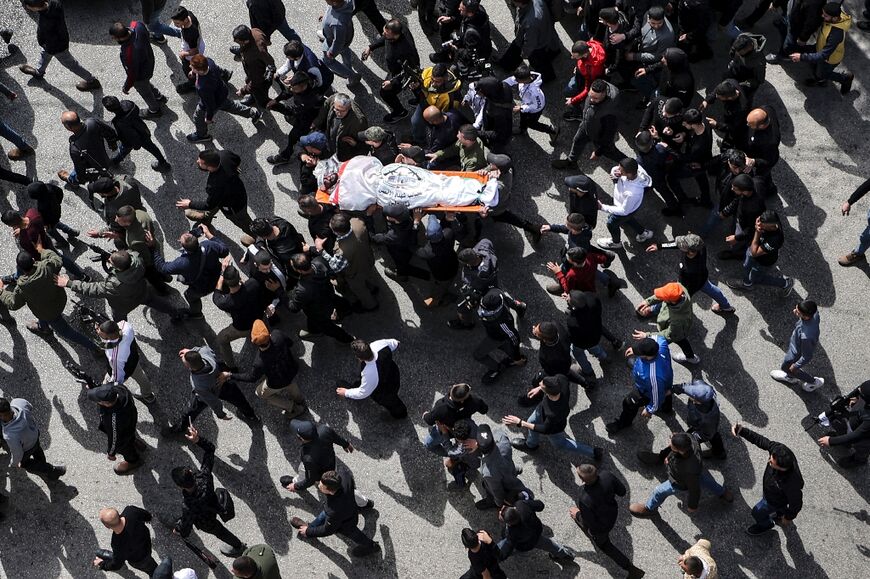 Mourners march with the body of one of several Palestinians killed during an Israeli army raid in the Jenin camp for Palestinian refugees 
