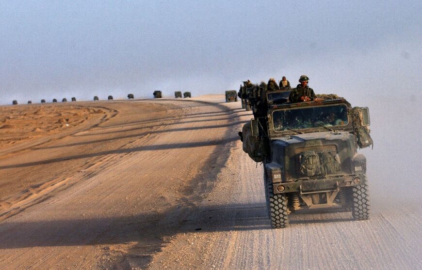 A convoy of US Marines from the 2nd Battalion, 8th Regiment cross the desert northwards near Diwaniya in central Iraq, in this file photo dated April 4, 2003 
