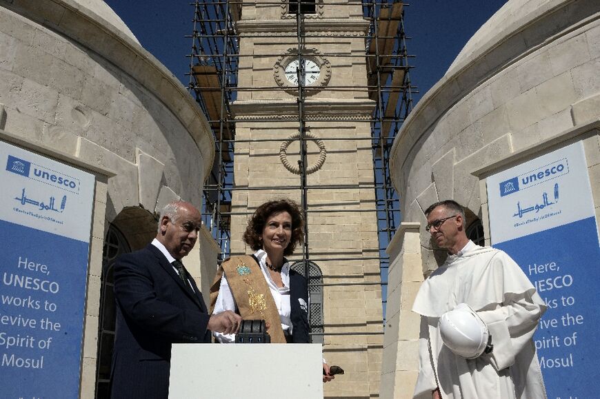 Azoulay (C) and Iraqi culture minister Ahmed Fakak al-Badrani (L) stand at the site where the three bells were being installed
