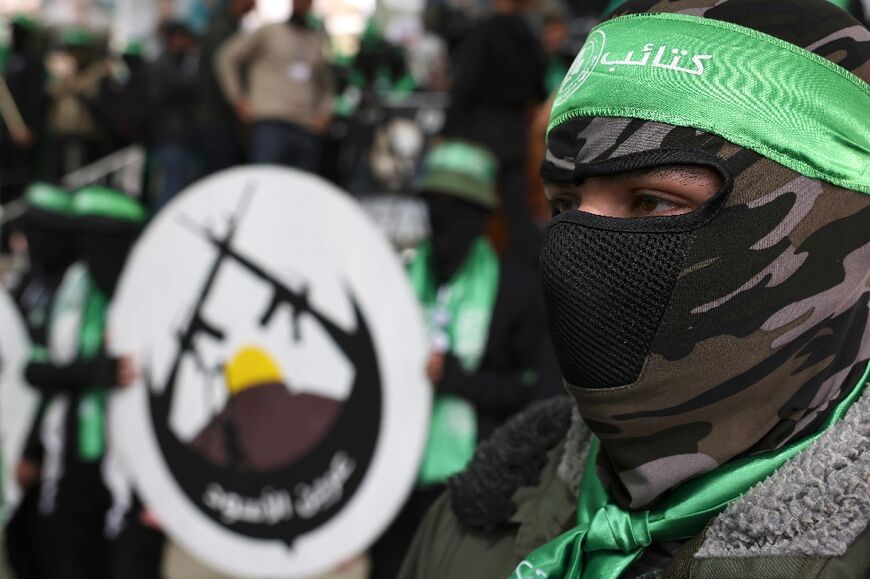 Student supporters of the Islamist Movement Hamas march during a university election campaign rally in the West Bank city of Hebron on March 13, 2023