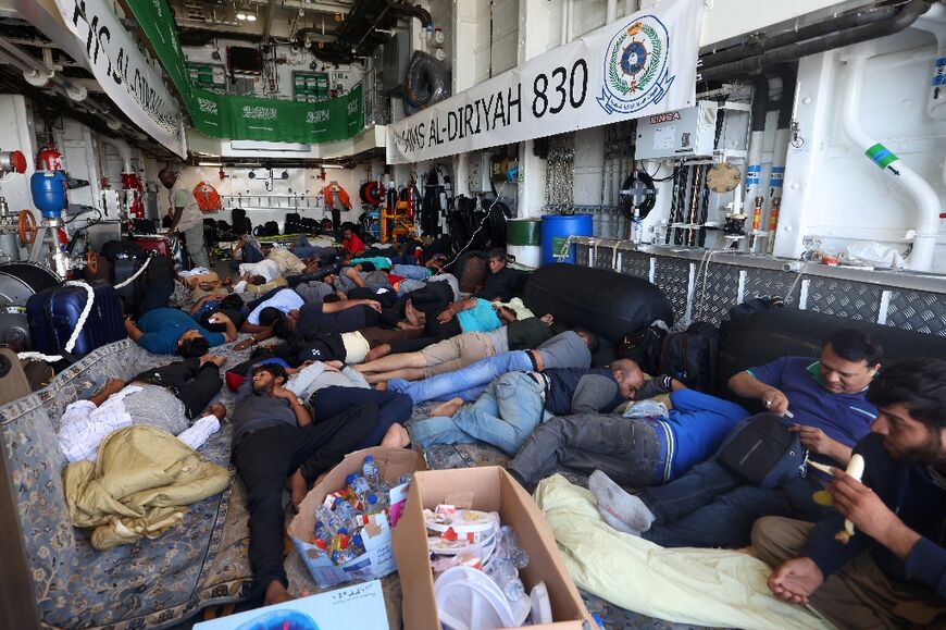 Evacuees rest on the Saudi Arabian warship HMS Al-Diriyah, transporting them from Port Sudan to Jeddah