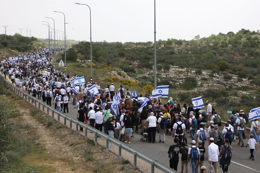 Hundreds of Israelis marched in the northern West Bank for state approval of an Israeli outpost settlement