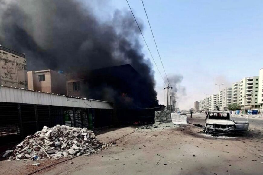 Smoke rises from a building on a street in Khartoum in this photo taken on April 23, 2023 and released by the Indonesian Foreign Ministry 