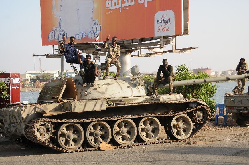 Sudanese army soldiers loyal to Abdel Fattah al-Burhan sit atop a tank in the Red Sea city of Port Sudan