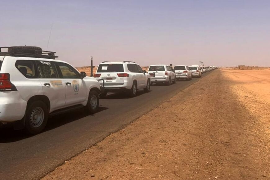 A convoy leaving Khartoum advances on a road towards Port Sudan, on April 23, 2023, as people flee the battle-torn Sudanese capital