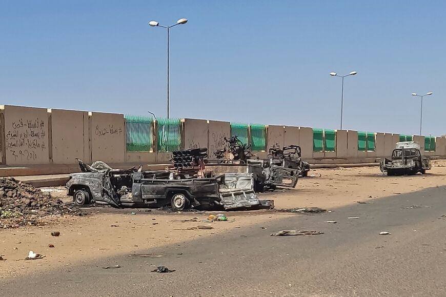 Destroyed vehicles beside a road in southern Khartoum