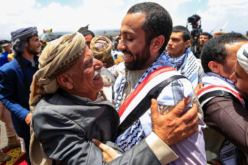 In Yemen, an elderly man embraces one of the returned Huthi prisoners exchanged in a deal with the internationally recognised-government upon arrival at Sanaa International Airport on Friday