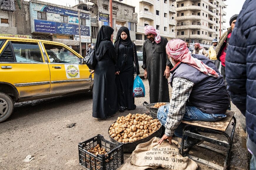 A merchant sells desert truffles in a market in Syria's rebel-held north, a region where collectors have been targeted by IS