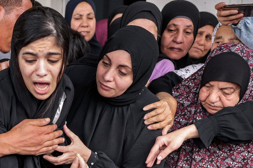 Family members mourn Palestinian teenager Mohamed Fayez Balhan, 15, who was killed during a Israeli raid in the Aqabat Jaber camp near Jericho in the occupied West Bank on April 10, 2023