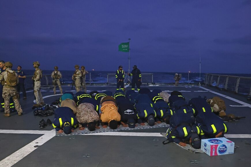 Saudi naval and special forces perform morning prayers aboard HMS Al-Diriyah during the evacuation operation from Port Sudan to Jeddah
