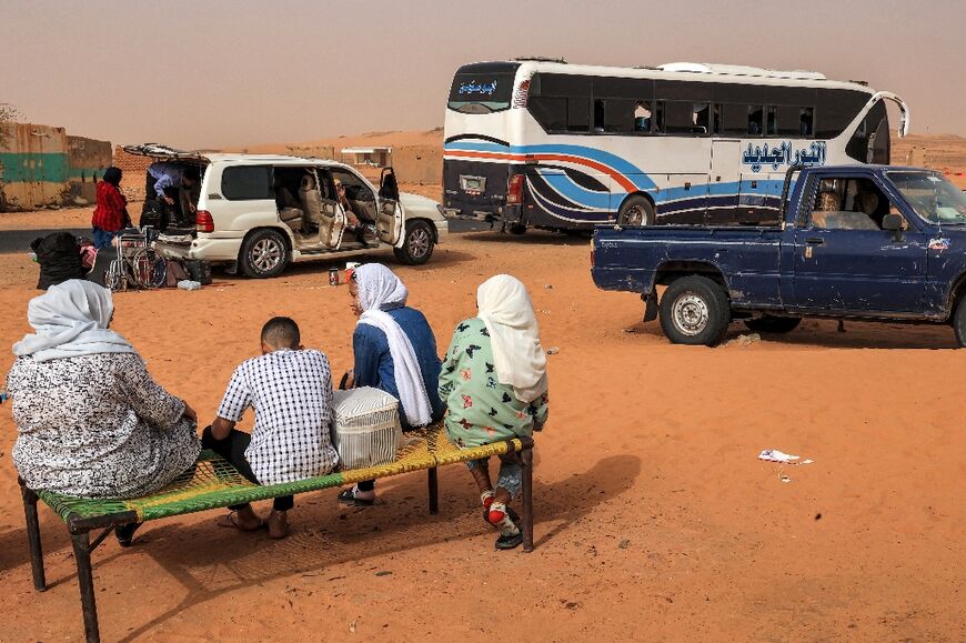 People stop at a rest-point by a desert road at al-Gabolab in Sudan's Northern State, about 100 kilometres northwest of the capital, on April 25, 2023