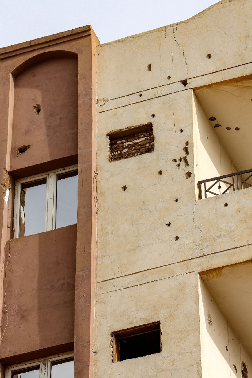 Bullet holes riddle the facade of a building in Khartoum 