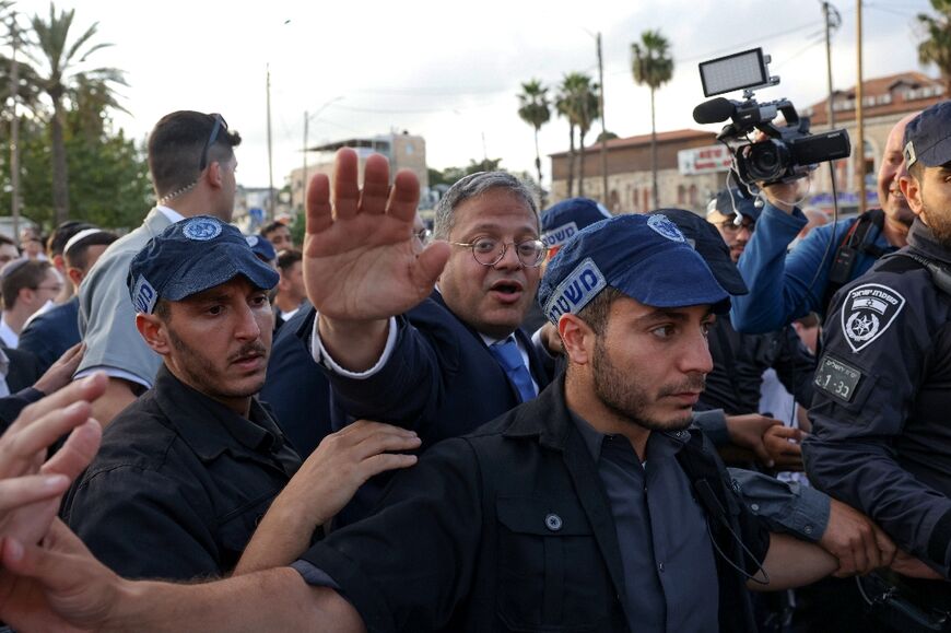 Flaaged by a police escort, far-right National Security Minister Itamar Ben-Gvir joins fellow Israeli nationalists marching into annexed east Jerusalem at Damascus Gate, a flashpoint in previous years 