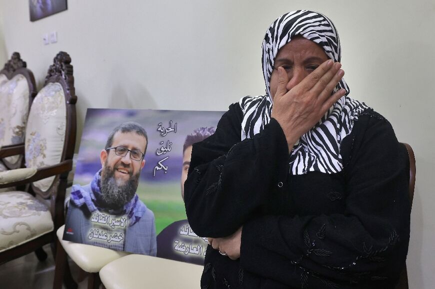 A relative mourns Palestinian prisoner Khader Adnan, who has died in Israeli custody after a hunger strike lasting nearly three months