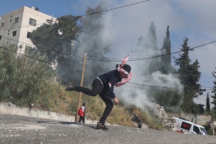 Palestinian protesters hurl rocks amid clashes with Israeli security forces during a raid in Nablus in the occupied West Bank, on May 9, 2023