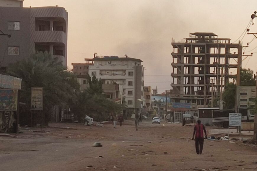 People walk on an almost empty street in southern Khartoum