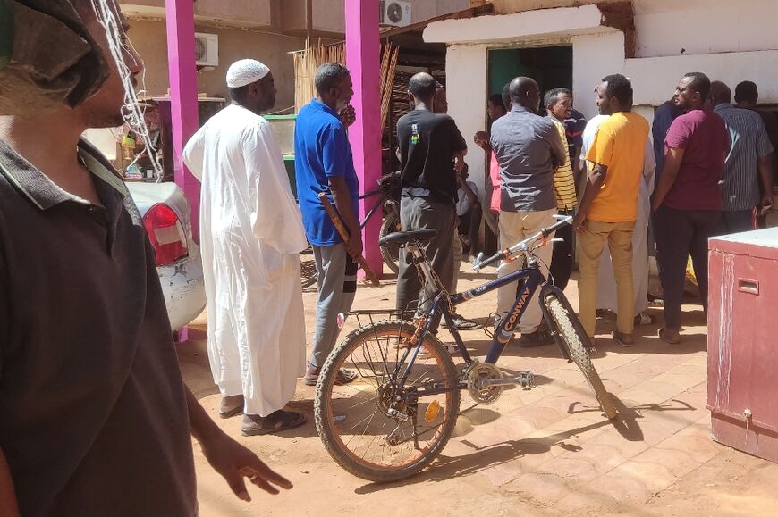 People queue in front of a bakery in southern Khartoum -- there are shortages of basic goods