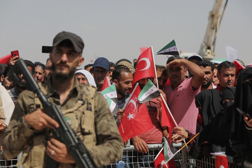 Syrians attend the inauguration of the Turkish-funded housing complex in the rebel-held north