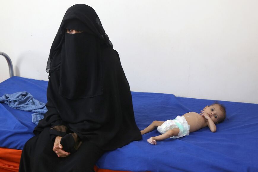 A Yemeni mother with her malnourished child at a treatment centre in the Khokha district of the western province of Hodeida on March 11, 2023