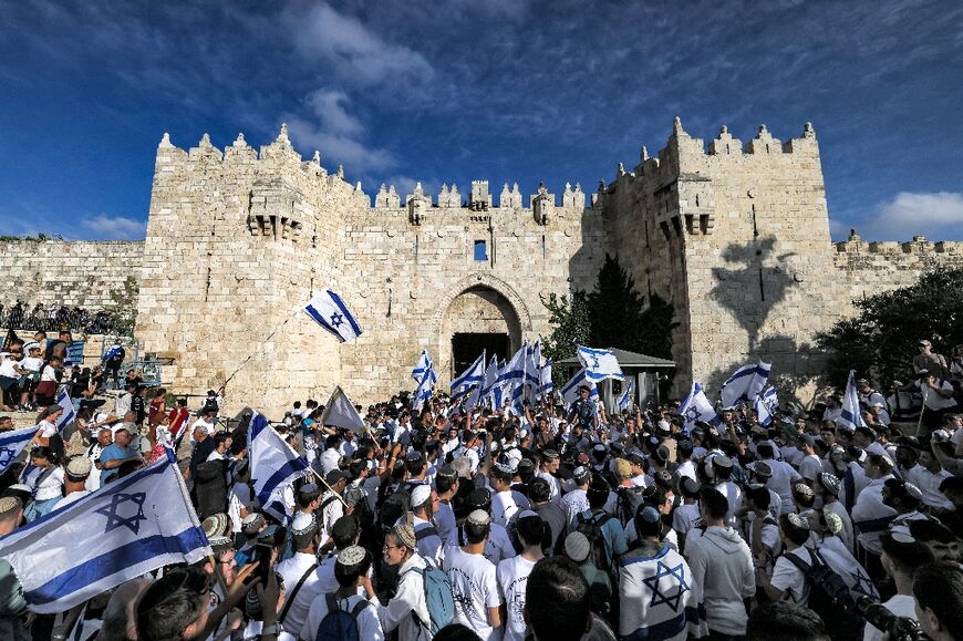 Thousands of Israeli nationalists taking part in the annual flag march commemorating Israel's 1967 capture of Arab east Jerusalem enter the walled Old City through Damascus Gate, which was closed to Palestinians for the occasion