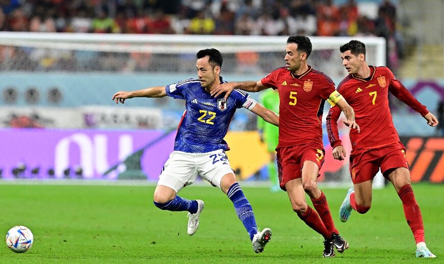 Maya Yoshida (L) in action against Spain's Sergio Busquets (C) and Alvaro Morata at last year's World Cup in Qatar