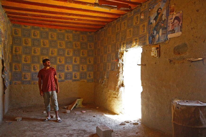 Rooms stripped of their doors and windows show signs of the lives that have been upended