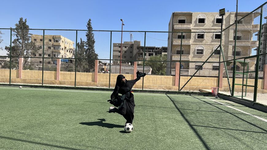 Sewsan Hemadah, a 22 year old martial arts teacher, playing football in Raqqa on April 25, 2023. (Amberin Zaman/Al-Monitor)