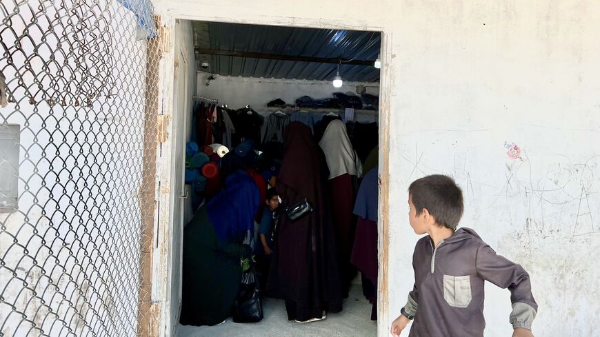 IS women detainees seen shopping at the Roj Camp market, April 29, 2023. (Amberin Zaman)