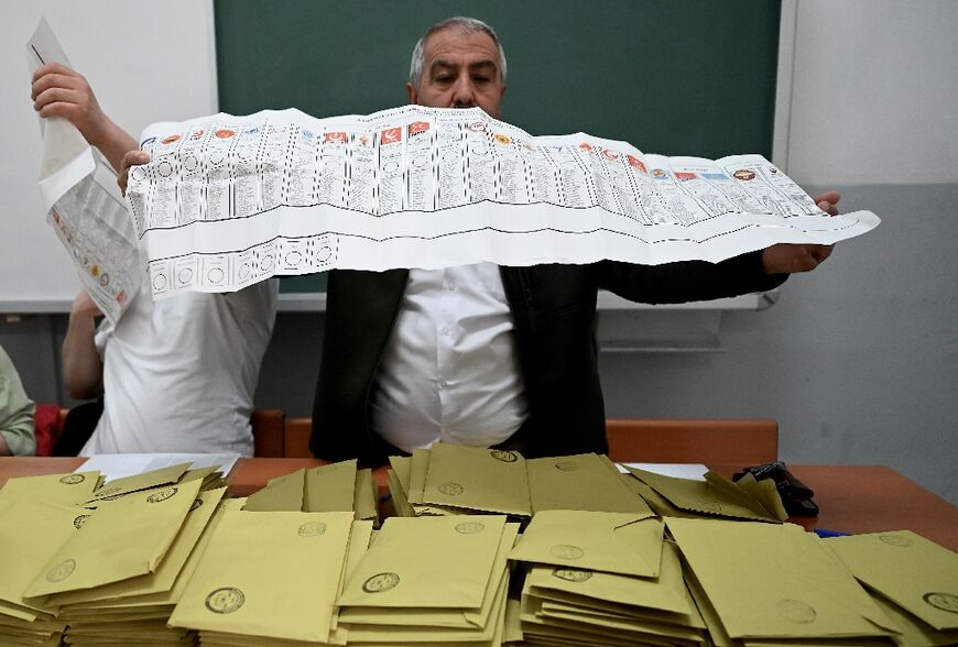 Turkish election officials spent a tense night counting ballots by hand in the knife-edge vote