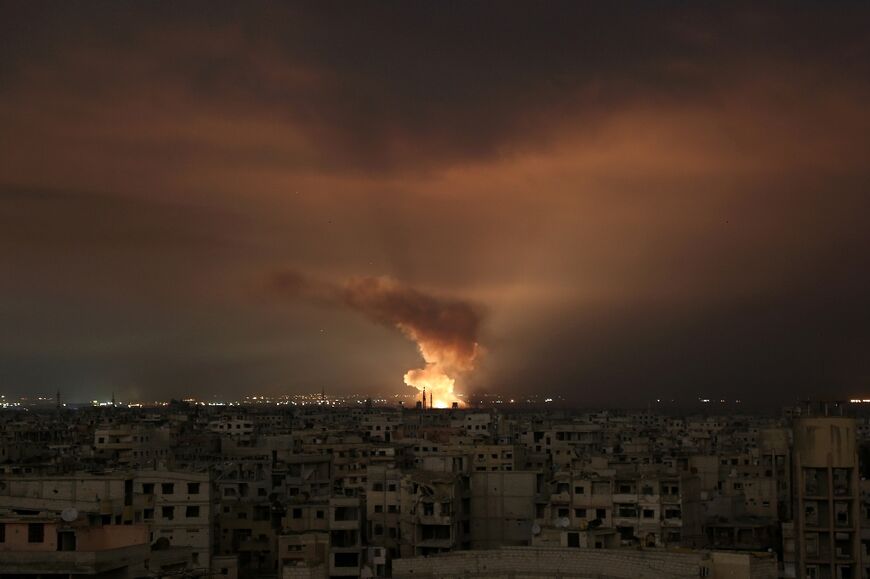 A file picture from Syria's war shows a regime air strike on the besieged Eastern Ghouta region on the outskirts of the capital Damascus, late on February 23, 2018