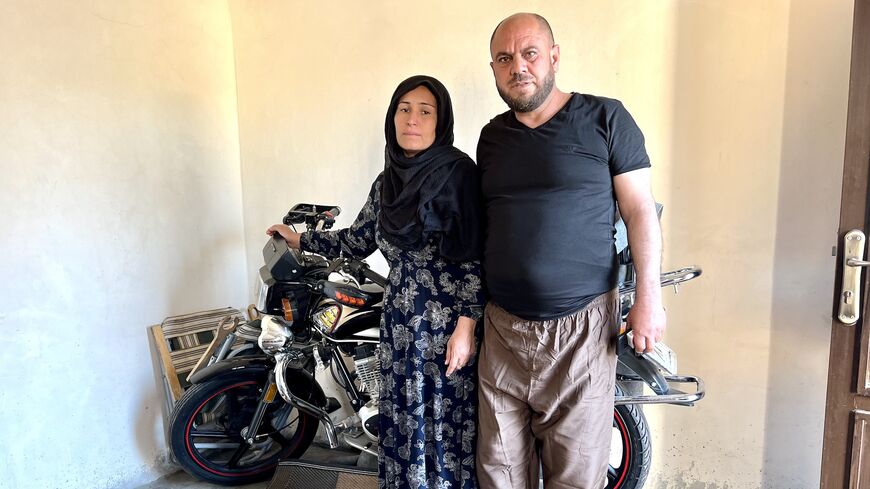 Faiza and Ali Hussain posing in front of their son Ahmed’s motorbike in Qamishli on April 26, 2023. Ahmed, 18, was killed in a Turkish drone strike on Aug. 6, 2022. (photo by Amberin Zaman)