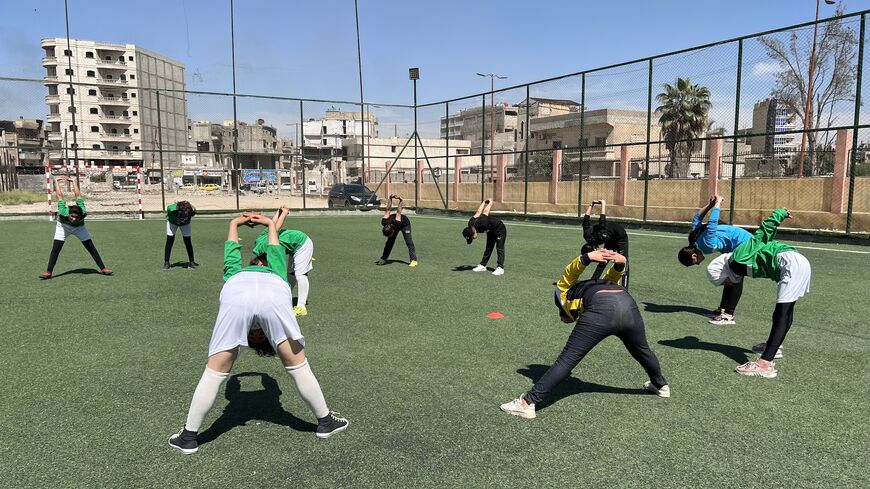 Raqqa’s first ever girls’ soccer team practicing on a pitch financed by Norwegian donors, April 25, 2023. (Amberin Zaman/Al-Monitor)
