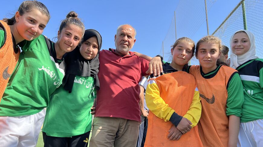 Girls’ soccer coach Ahmed Abeid posing with his team in Raqqa, April 25, 2023. (Amberin Zaman/Al-Monitor)
