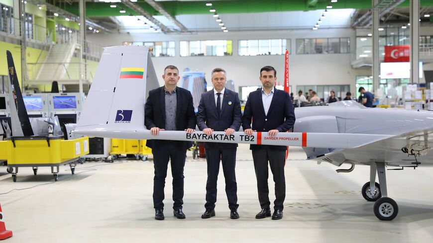 Selcuk Bayraktar (right) at a ceremony with Lithuanian officials to hand over a TB2 drone intended for Ukraine. (Twitter/BaykarTech)