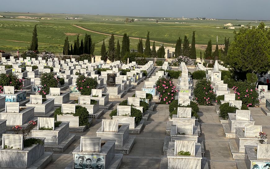 The Rustem Cudi cemetery near Coughing Donkey Village in Al-Darbasiyah, where SDF fighters and other war  martyrs are buried, April 27, 2023. (Amberin Zaman)
