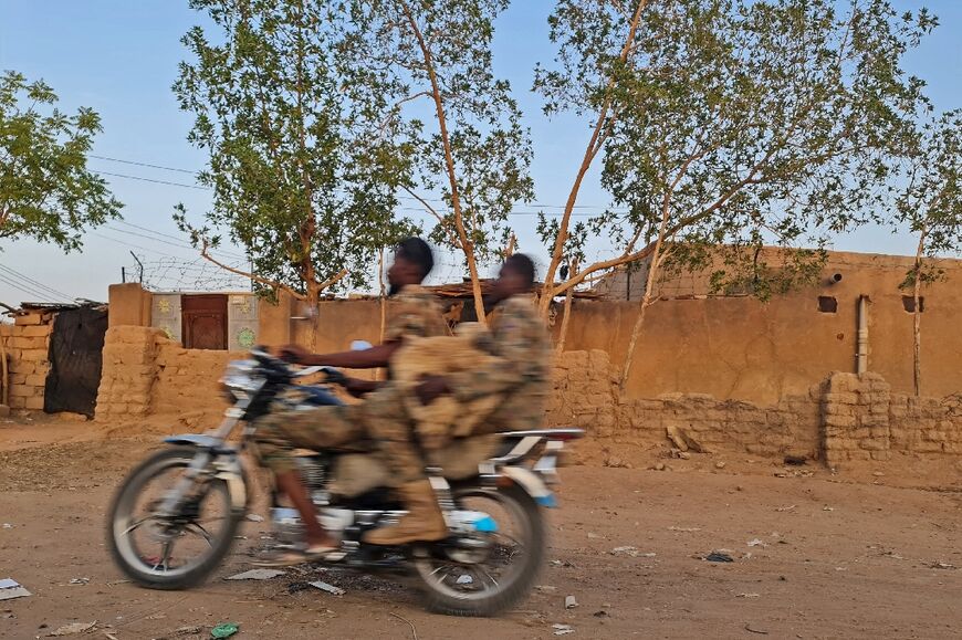 Sudanese army soldiers ride a motocycle in Khartoum, on June 26, 2023