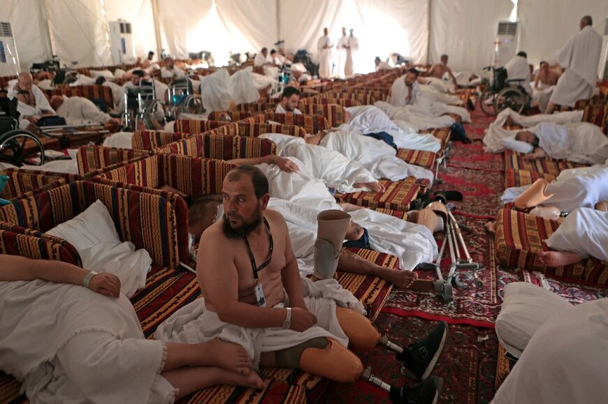 Syrian amputees rest inside their tent near Mount Arafat