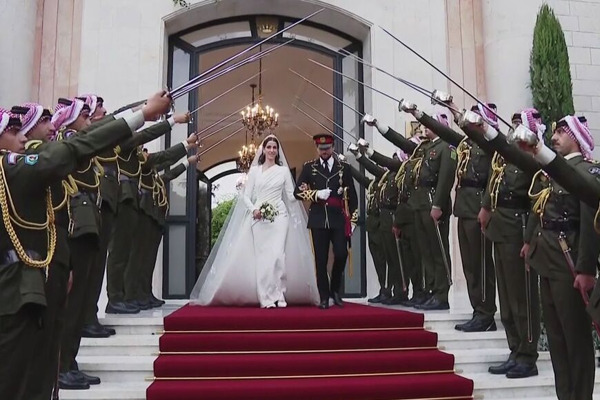 A screen grab from footage released by the Jordanian Royal Palace shows the newly weds leaving the Zahran Palace in Amman