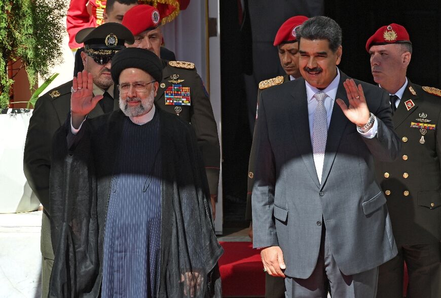 Raisi and Venezuelan President Nicolas Maduro stand together during a welcoming ceremony in Caracas